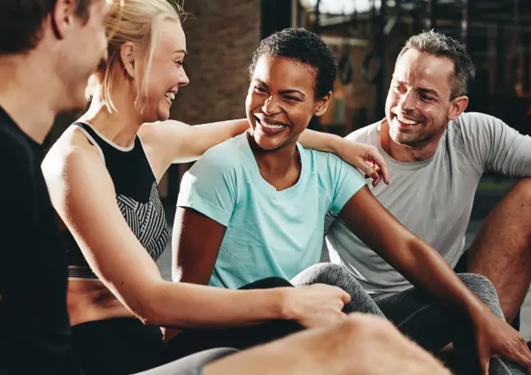 Image of Gym members sharing a gym software management on a mobile device answering the question what is gym management software