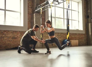 Image of a trainer helping a member with functional fitness training
