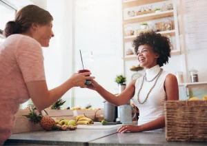 Image of a woman buying a smoothie from a local business