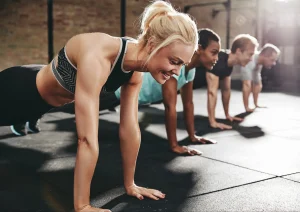 Image of gym members doing pushups for an intensive workout gym fundraising idea