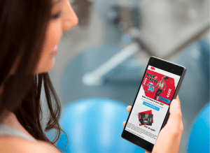 Image of a woman looking at a referral email on her mobile device