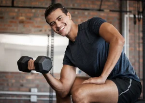Image of a man in a gym lifting a weight