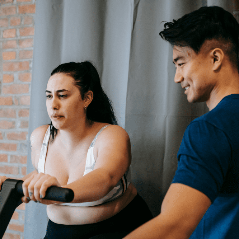Image of an instructor helping out a member using cycling studio software