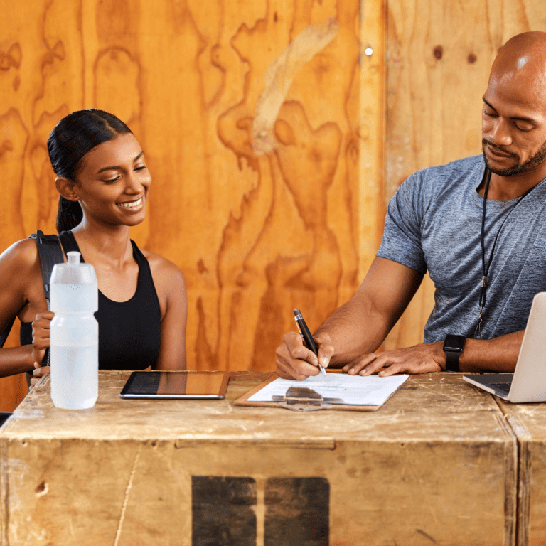 Image of owner going over gym billing with a member